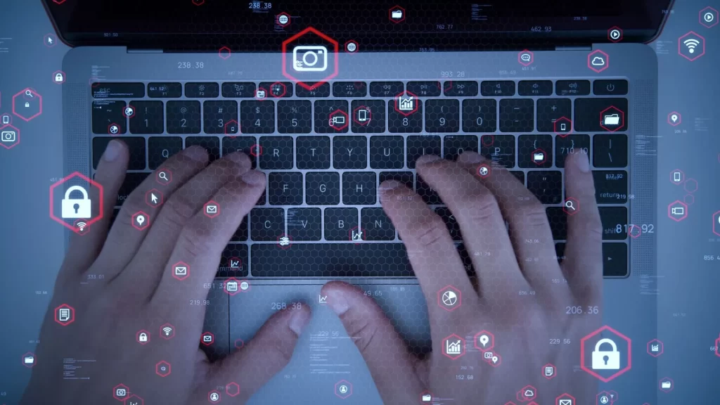 A pair of hands is typing on a keyboard. Icons related to SaaS is superimposed on the photo.