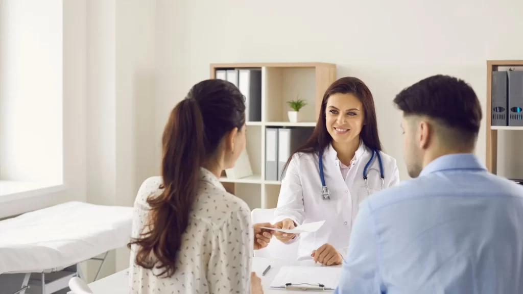 A doctor in a consultation with a patient who is a referral