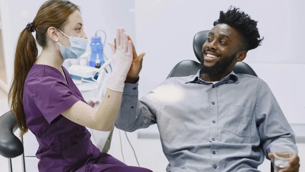 A doctor and her patient doing a high five