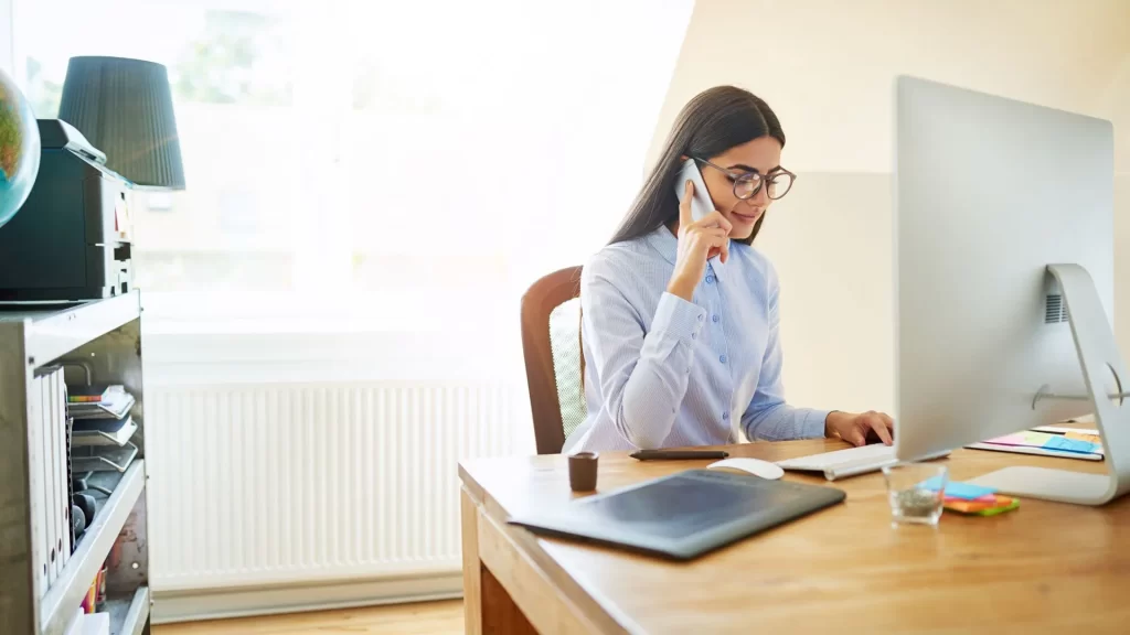 A financial advisor in a call while using her laptop and analyzing local SEO