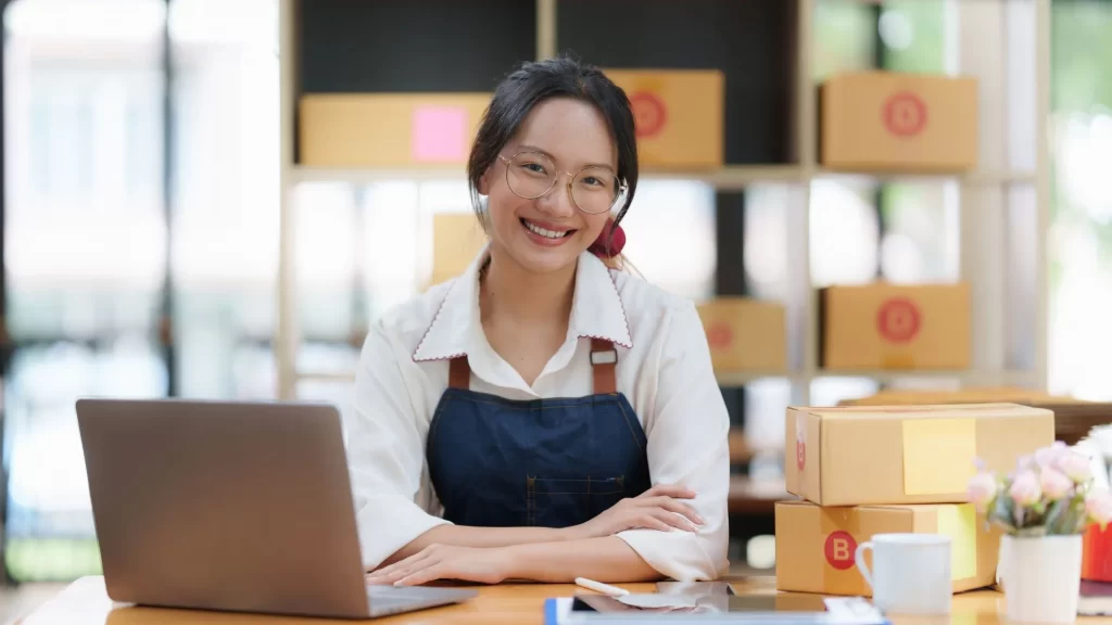 A woman entrepreneur smiling while contemplating content marketing strategies for local SEO