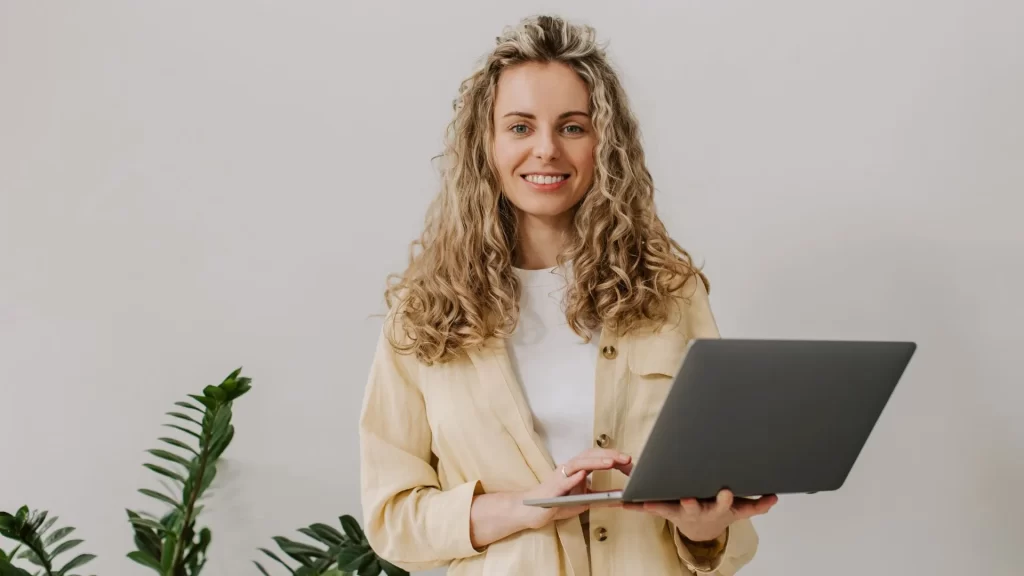 An owner of a landscaping company with her laptop