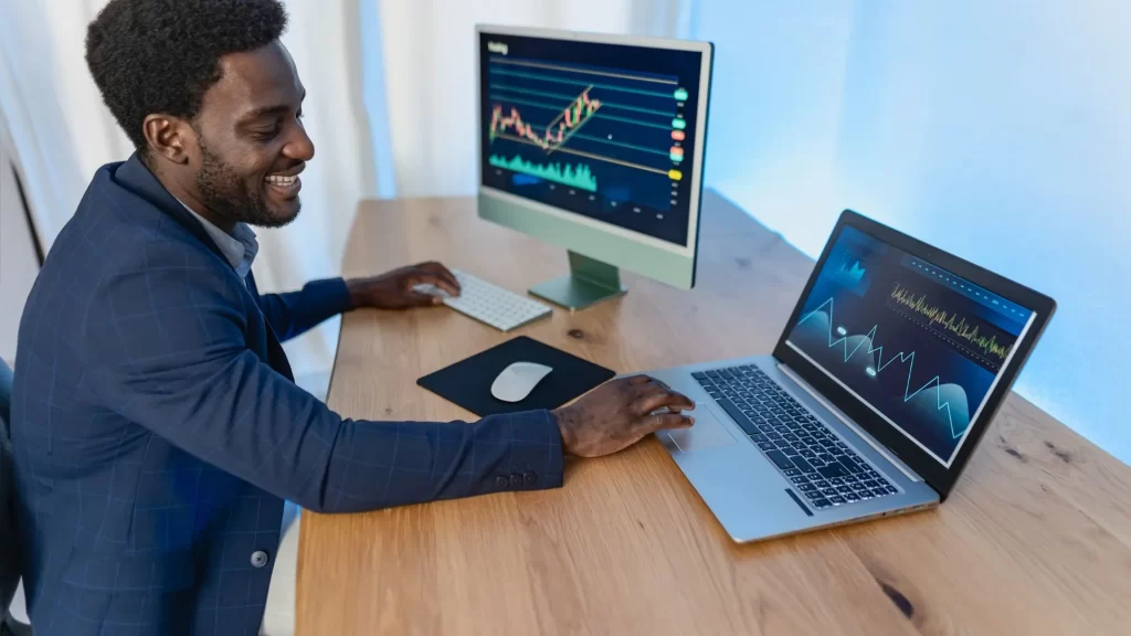 Business owner smiling while looking at increased organic traffic to his website