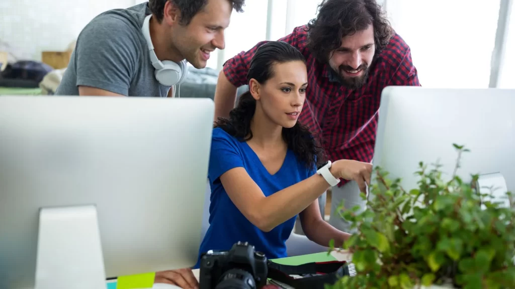Three professionals working on content optimization strategies for organic traffic
